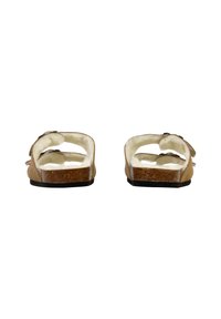 Brune semskede sandaler med en blød, cremefarvet foring, korksål og justerbare remme. Åbenbag-design med minimale udsmykninger.