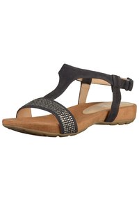 Svart mockasandal med en strukturerad brun innersula, justerbart vristband och ett band prytt med rhinestones. Flexibel gummisula.