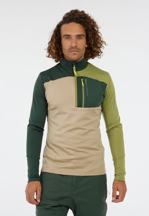 Half-zip, long-sleeve shirt in green, beige, and olive with a front pocket and logo detail; made of smooth, lightweight fabric.
