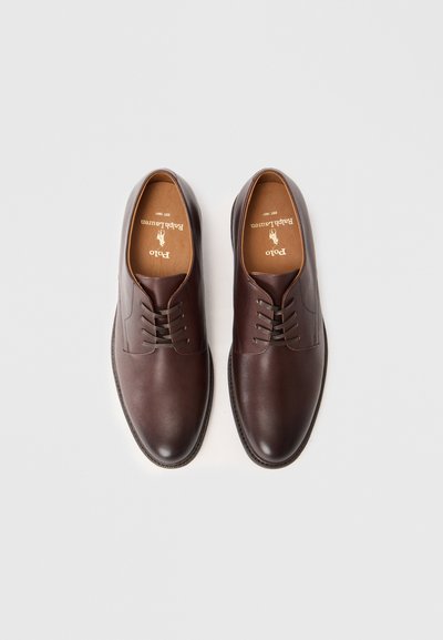 Pair of dark brown leather lace-up dress shoes with tan interior and Polo Ralph Lauren logo inside, shown from above on white background.