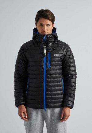 Zwarte pufferjas met blauwe accenten, voorzien van een ritssluiting, capuchon en gestikt patroon. Logo op de borst en rits weergegeven.