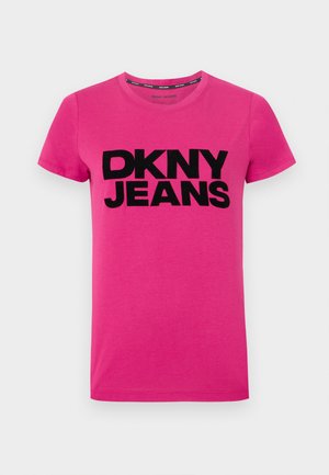 T-shirt rose à manches courtes en coton, arborant un logo noir en gras "DKNY JEANS" sur le devant. Encolure ronde simple, texture lisse.