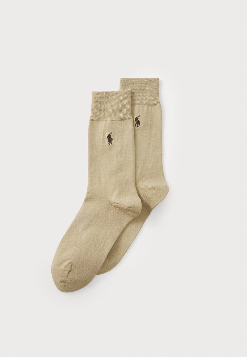 Beige värvi kesk-sääre sokkidepaar ribitud äärtega ja tumepruuni tikandiga polo mängija logoga külgedel.