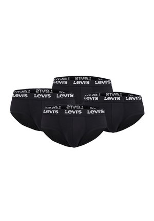 Male model wearing black Levi's briefs with branded waistband, showing upper torso and legs against a plain light background.