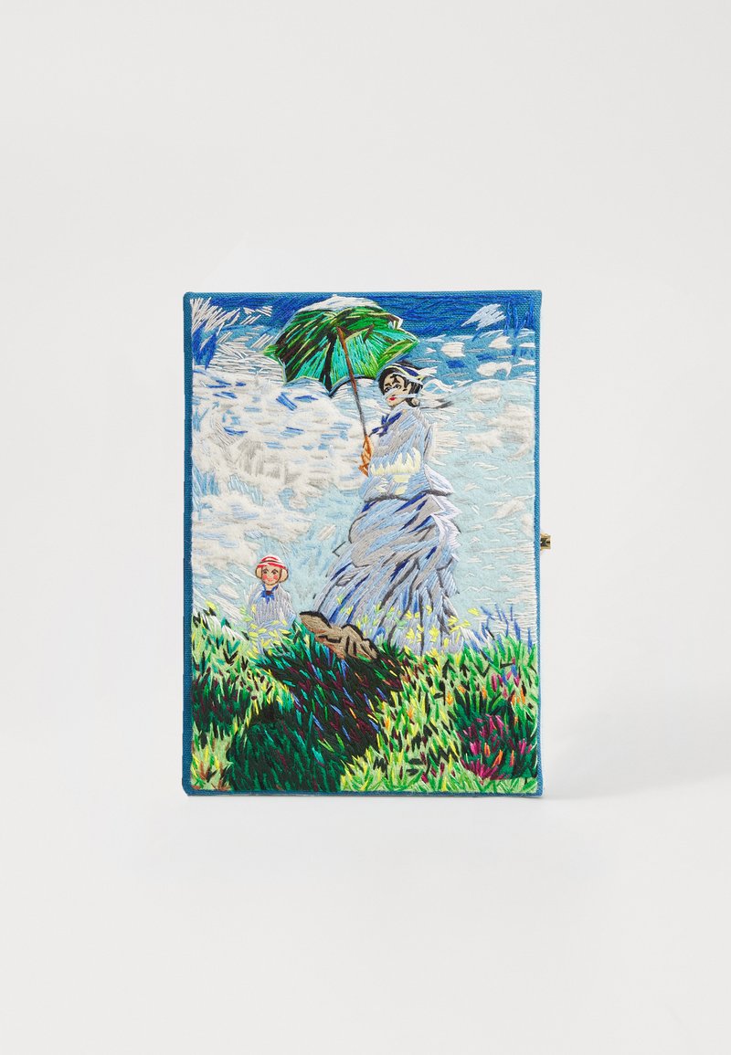 Embroidered rectangular clutch featuring a woman with a green umbrella, surrounded by grass, flowers, and a child. Blue and white background.