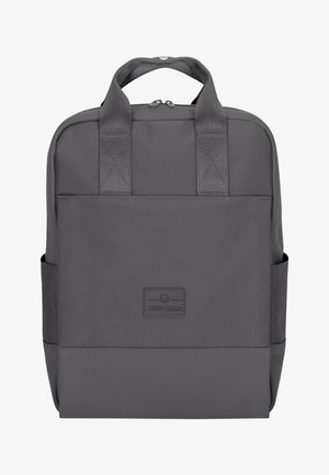Mochila de tela gris con dos asas en la parte superior, superficie texturizada, fondo plano y bolsillos laterales. Presenta un parche de logo en la parte frontal.