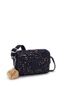 Navy bag with gold star pattern, rectangular shape, synthetic material, adjustable strap, featuring a plush monkey keychain attached.