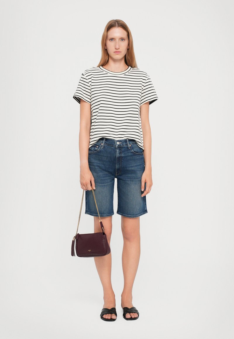 Striped short-sleeve t-shirt, blue denim shorts, black flat sandals, and a small burgundy crossbody bag with a chain strap.