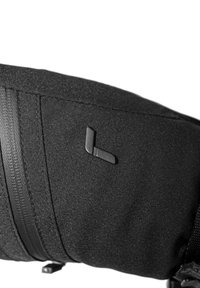 Black fabric backpack with textured surface, featuring a subtle logo accent and zipper elements. Compact design with adjustable straps.