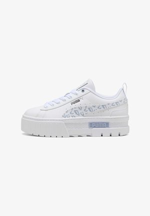 Biały sneaker Puma z grubą podeszwą, jasnoszarym wzorem w panterkę na pasku, logo Puma z boku i na podeszwie, sznurowane zapięcie oraz pętelka na pięcie.