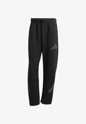 Sorte athletic bukser med elastisk talje og snøre. Har reflekterende detaljer og afslappede ben for en moderne pasform. Blød stof tekstur.