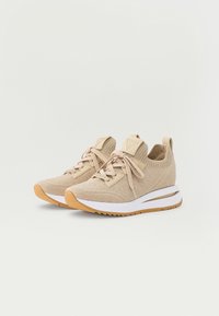 Beige knit fabric sneakers with white midsoles, gum rubber outsoles, lace-up design, and tonal pull tabs at heel collar.