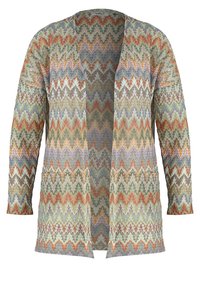 Cardigan en tricot à ouverture devant avec motifs zigzag et chevrons multicolores dans des tons terreux de vert, orange, violet et beige.