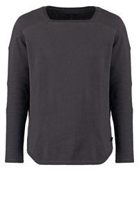 Sudadera negra de manga larga hecha de una mezcla de algodón. Presenta un escote cuadrado, mangas raglán y un dobladillo inferior recto con aberturas laterales.