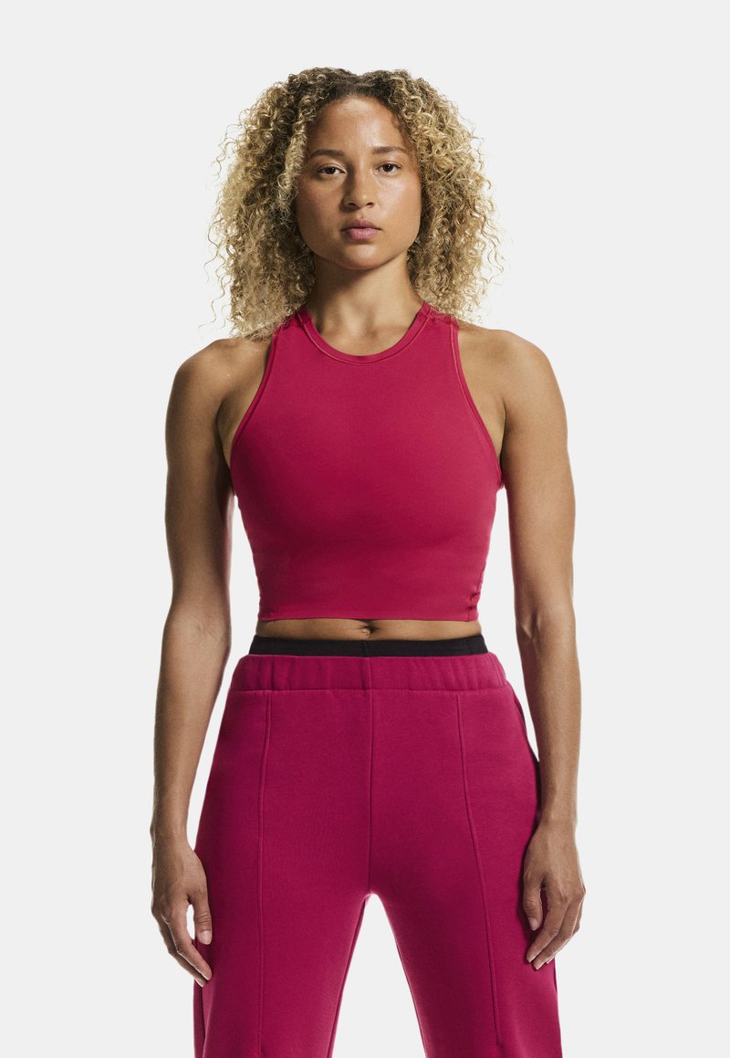 Rød, cropped tanktop med rund halsudskæring, parret med matchende højtaljede bukser med en sort elastisk talje og fine sømme.