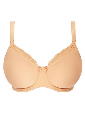 Beige formad bh med spetsdetaljer, justerbara axelband och en dekorativ rosett i mitten; slät yta och formad form för stöd.