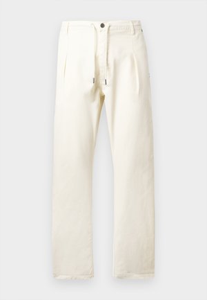 Heledad beige püksid, mis on valmistatud puuvillast ja millel on relaxed fit, joonisega talje, kaks esistotsi ja metallist detailid.