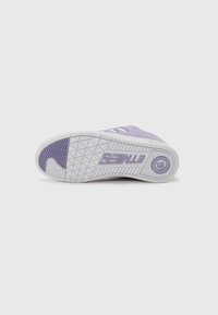 Purple sneaker with a textured sole featuring geometric patterns. White rubber outsole and brand logo embossed on the heel area.