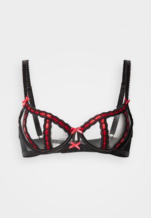 Soutien-gorge en dentelle noire avec panneaux en mesh transparent, accents rouges à bords festonnés, et petits nœuds roses sur les bretelles et au centre.