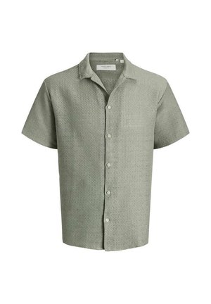 Chemise à manches courtes gris clair texturée avec boutons et col, présentée sur fond blanc.