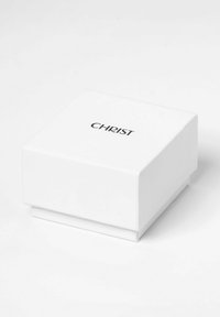 Weißer quadratischer Schmuckkasten mit "CHRIST" in Schwarz auf dem Deckel, vor einem weißen Hintergrund präsentiert.