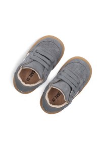 Gray suede sneakers with perforated upper, flexible gum rubber soles, dual elastic straps, and beige lining. Brand logo displayed on sides.