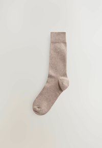 Beige gestrickte Socke mit Rippenbund, glatter Textur und subtiler Markenlogo Nähe des Knöchels. Entwickelt für Komfort und Alltagsgebrauch.