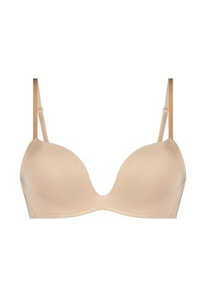 Soutien-gorge beige rembourré avec coques moulables, bretelles réglables et texture lisse. Présente un design sans coutures pour une apparence épurée.