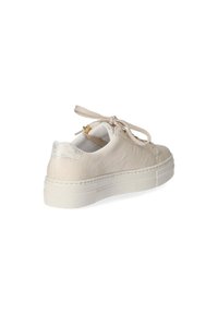 Beige leather sneaker with textured heel accent. Features a round toe, flat rubber sole, and fabric laces, designed for casual wear.