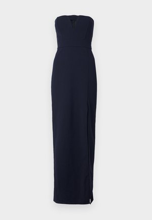 Robe sans manches bleu marine avec un décolleté en V, corsage ajusté et une longue jupe dotée d'une fente sur le côté et d'une fermeture éclair arrière dissimulée.