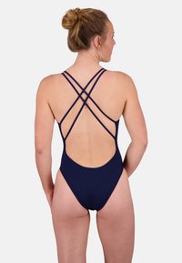 Navy blue one-piece swimsuit with crisscross straps and a deep back cutout. Made from smooth, stretchy fabric with a fitted design.