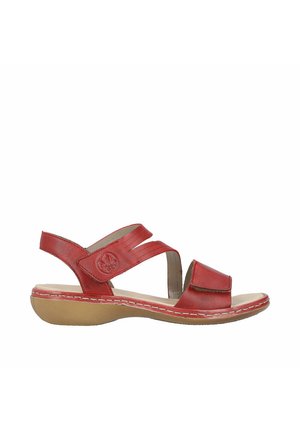 Sandale en cuir rouge avec un design à croisement et fermeture Velcro réglable. Semelle intérieure rembourrée et semelle en caoutchouc pour un confort et une stabilité accrus.