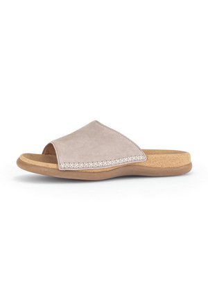 Soft beige slide sandal with a suede upper, open toe, and a textured cork footbed. Decorative stitching along the edge adds detail.