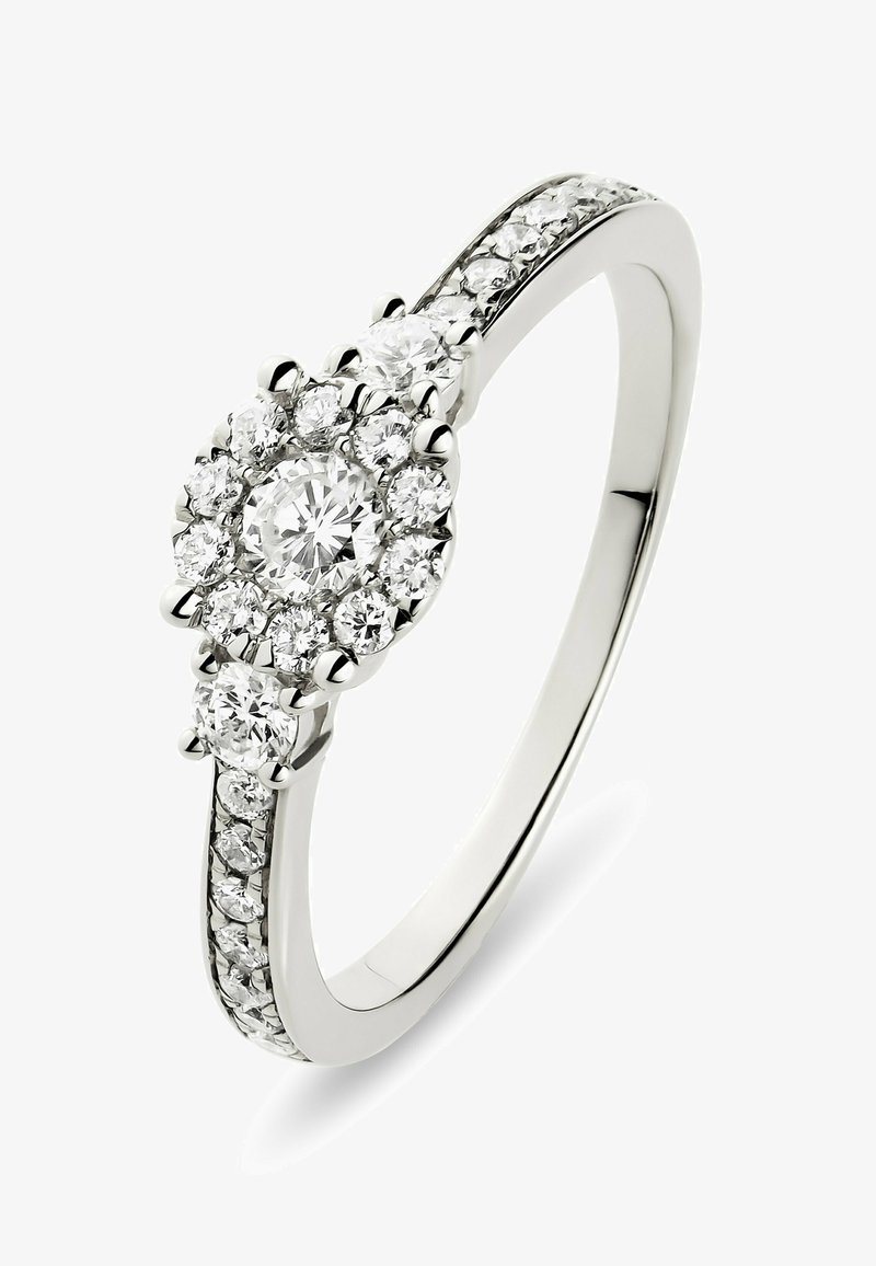 White gold ring with round central diamond surrounded by smaller diamonds, additional diamonds set along the band.