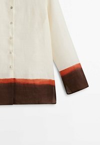 Light beige shirt with a buttoned front, long sleeves, and a hem featuring a gradient of orange to dark brown at the cuffs.
