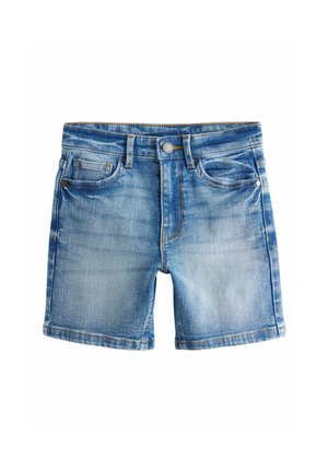 Traper hlačice svijetlo plave boje s izblijedjelim efektom. Sadrže pet džepova, proreze za remen, kopčanje na gumb i blago oštećenje tkanine.