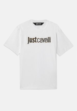 White short-sleeve t-shirt with faded black and gold "Just cavalli" text printed across the chest and a black label inside the collar.