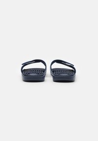 Navy blue sandals with woven texture, flat soles, and two wide straps. Simple design suitable for casual wear.