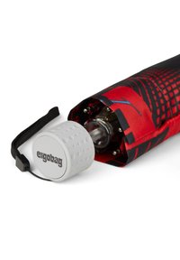 Red and black printed umbrella with a textured white handle labeled "ergobag," partially closed to reveal the mechanism inside.