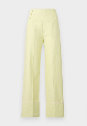 Pantaloni a gamba larga in tessuto giallo chiaro con una texture liscia. Presentano una vita alta e cuciture a contrasto lungo l'orlo.