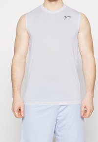 Sleeveless light purple athletic shirt made from moisture-wicking fabric, featuring a small black Nike logo on the upper left side.