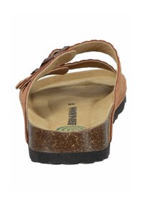 Brown suede sandals with an open design, featuring layered straps and a textured cork footbed. Black rubber sole visible at the bottom.