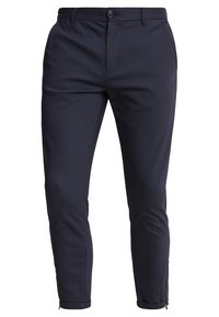 Mörkblå, slim-fit byxor gjorda av textil med struktur, med framfickor, dragkedja vid ankeln och knappstängning.