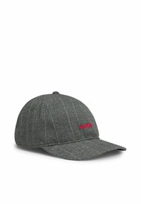 Gray checkered cap with a flat visor, featuring red "HUGO" embroidery and subtle yellow accent lines. Made from textured fabric.