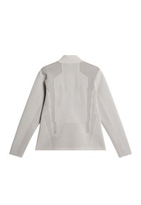 Chemise blanche à manches longues avec col, présentant un motif texturé, des détails perforés et un texte au dos. Fini en tissu lisse.