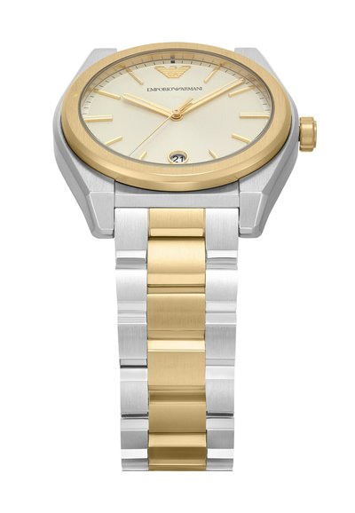 Miestrovské hodinky so zaobleným puzdrom z pozlátenej a striebornej nerezovej ocele, strieborným ciferníkom, zlatými indexmi a bi-color náramkom. Obsahuje zobrazenie dátumu.