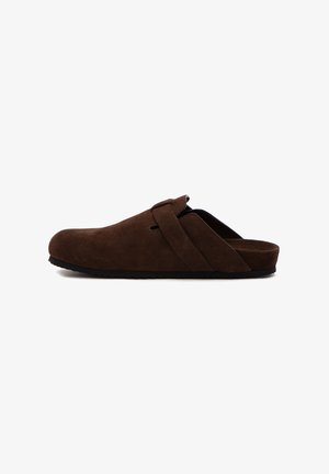 Brown suede slip-on clog with adjustable strap and black sole, designed for indoor or casual wear.