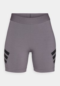 Šedé elastické sportovní šortky s širokým pasem a třemi černými diagonálními pruhy na každém stehně, vystavené na bílém pozadí.