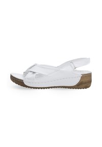 Witte leren wedge sandalen met een kruisriemontwerp en een gestructureerde bruine rubberen zool. Open achterkant voor gemakkelijke hantering.