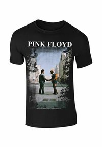 Černé bavlněné tričko se grafickým potiskem dvou postav, které si podávají ruce, přičemž jedna je v plamenech. Text nahoře zní "PINK FLOYD."